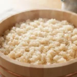 Perfectly prepared sushi rice in a wooden bowl with a glossy finish